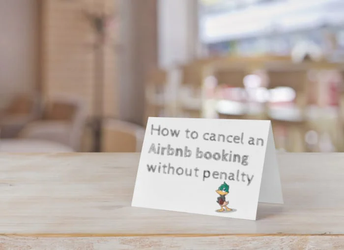 A small white card on a wooden table displaying text about how to cancel an Airbnb booking without penalty.